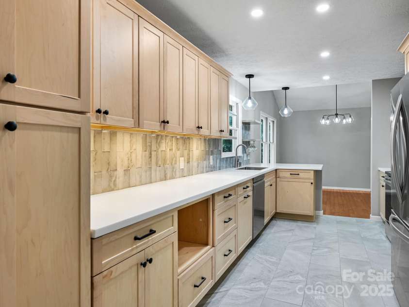 210 Fernwood Drive, Hendersonville, NC 28791.  MLS# CAR4275112, YatesRealty ID 22697. Kitchen has natural wood cabinets incl pantry