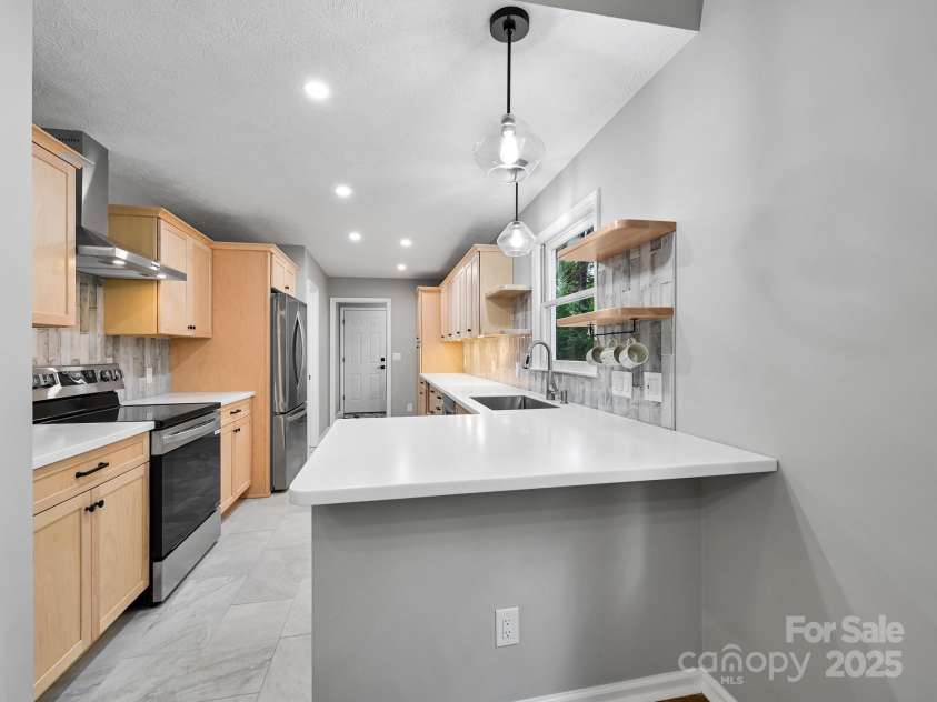 210 Fernwood Drive, Hendersonville, NC 28791.  MLS# CAR4275112, YatesRealty ID 22697. Stone Counters ready for stools.