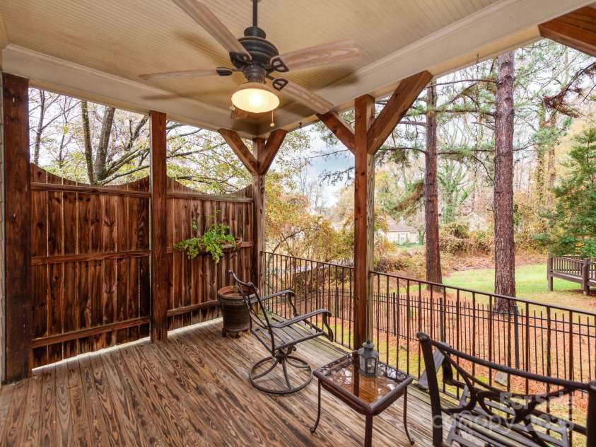 501 River Oaks Lane, Charlotte, NC 28226.  MLS# CAR4192085, YatesRealty ID 22698. Step into a beautiful outdoor balcony space designed for relaxation and entertaining. This inviting area features lush landscaping, ample seating, and seamless access from the main living spaces. Whether you’re hosting