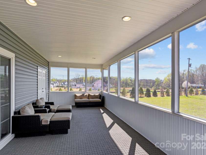 15020 Ranson Road, Huntersville, NC 28078.  MLS# CAR4266705, YatesRealty ID 22703. Screened porch off the Primary Bedroom