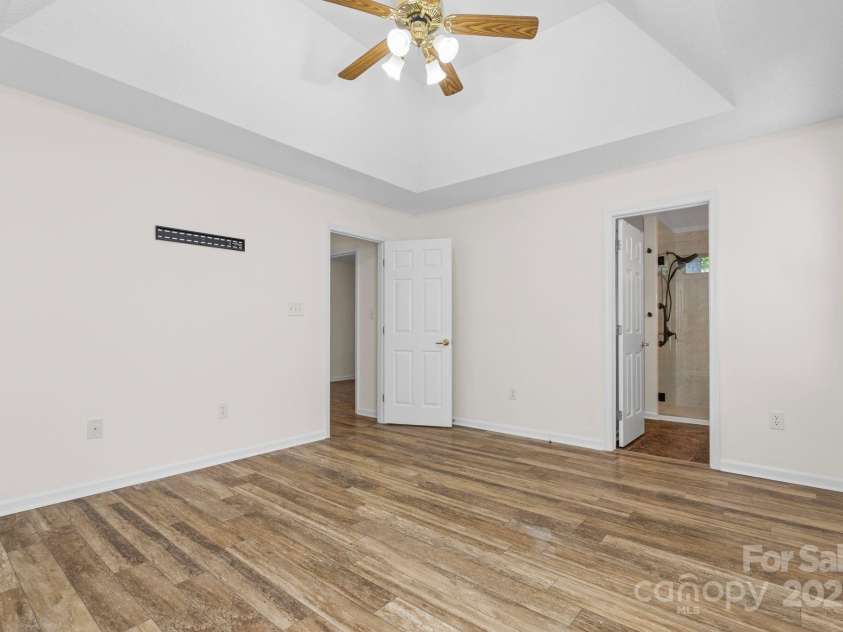 131 Canopy Court, Mooresville, NC 28115.  MLS# CAR4268984, YatesRealty ID 22713. Another view of the bright and airy primary suite with ensuite bath entry.