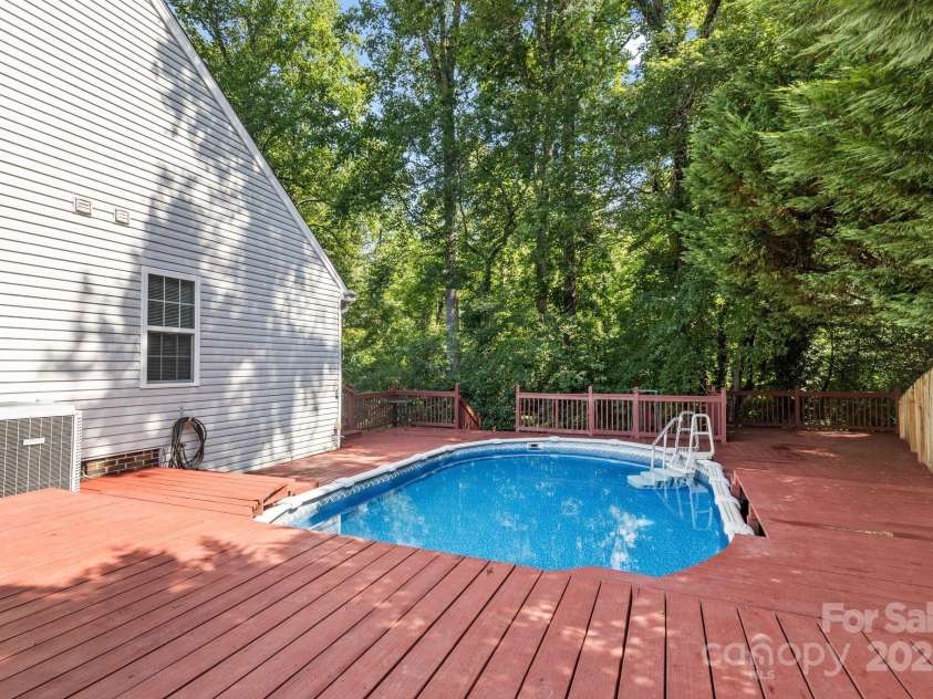 131 Canopy Court, Mooresville, NC 28115.  MLS# CAR4268984, YatesRealty ID 22713. Backyard pool deck offers room for sunbathing, grilling, or gathering.