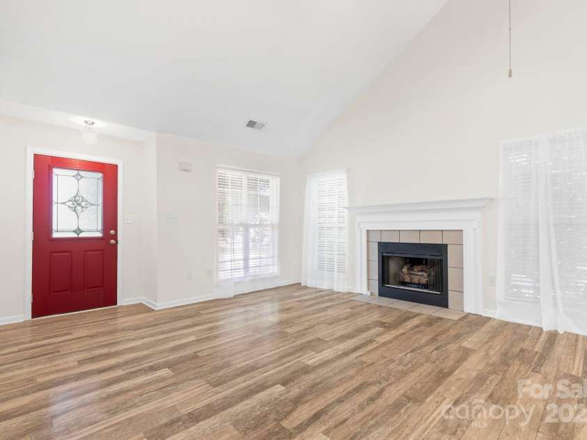 131 Canopy Court, Mooresville, NC 28115.  MLS# CAR4268984, YatesRealty ID 22713. Bright entry with statement red door, large windows, and open flow into the living space.