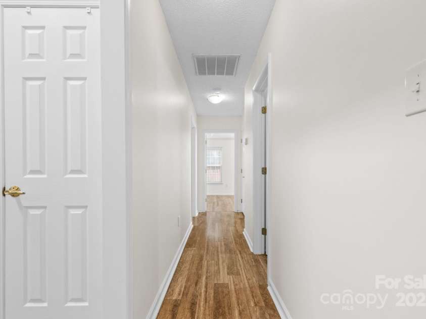 131 Canopy Court, Mooresville, NC 28115.  MLS# CAR4268984, YatesRealty ID 22713. Central hallway connects all bedrooms—freshly painted and move-in ready.