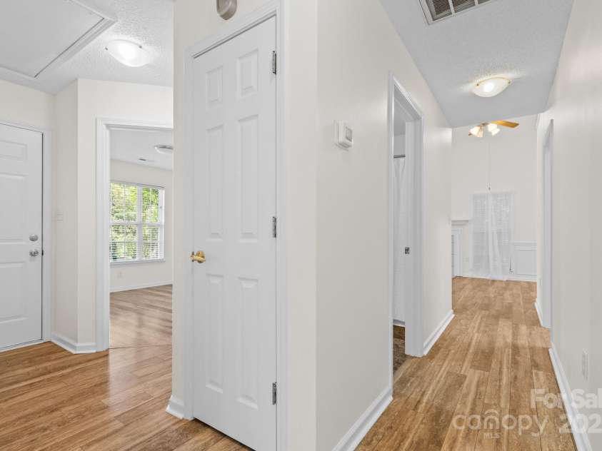 131 Canopy Court, Mooresville, NC 28115.  MLS# CAR4268984, YatesRealty ID 22713. Central hallway with access to laundry, garage, and pull-down attic—efficient layout with great storage flow.
