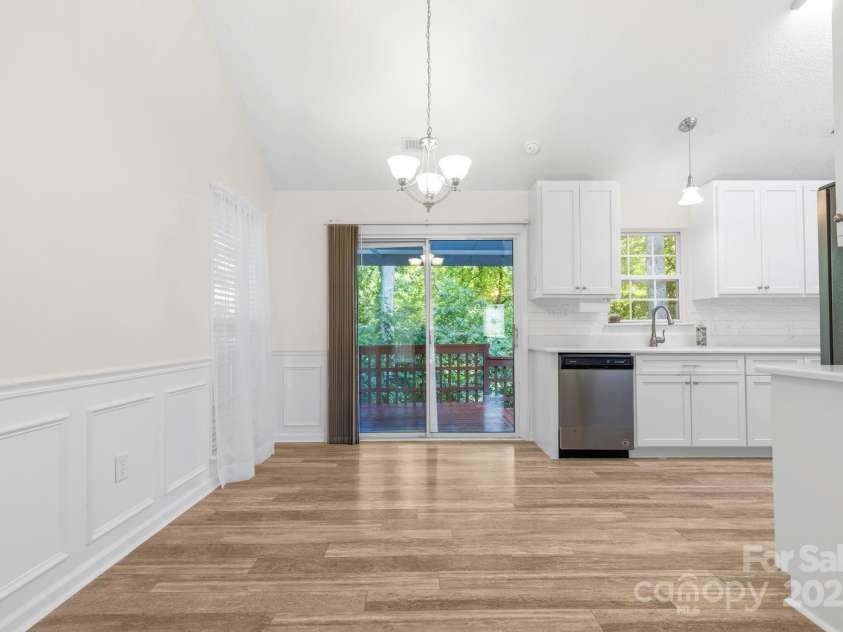 131 Canopy Court, Mooresville, NC 28115.  MLS# CAR4268984, YatesRealty ID 22713. Dining area with custom wainscoting and access to the back deck for easy indoor/outdoor flow.