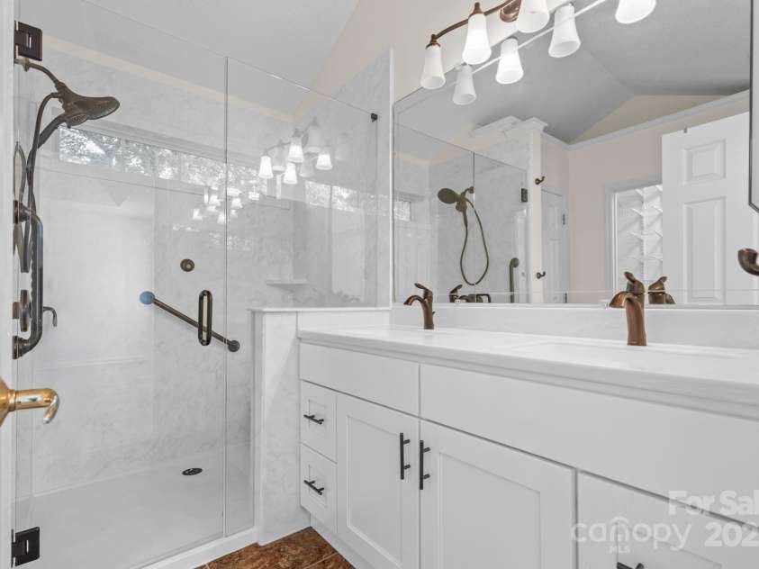 131 Canopy Court, Mooresville, NC 28115.  MLS# CAR4268984, YatesRealty ID 22713. Fully updated primary bath with double vanity and walk-in tiled shower.