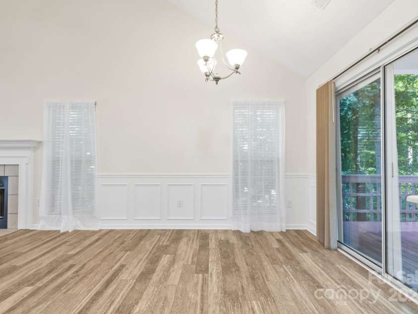 131 Canopy Court, Mooresville, NC 28115.  MLS# CAR4268984, YatesRealty ID 22713. Glass slider opens to private wooded views—ideal for morning coffee or relaxing evenings.