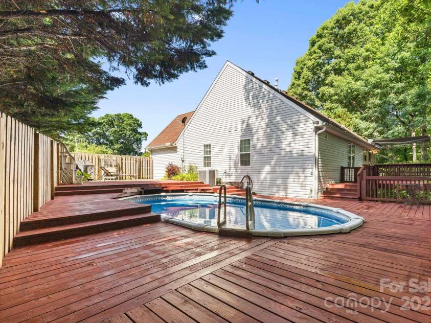131 Canopy Court, Mooresville, NC 28115.  MLS# CAR4268984, YatesRealty ID 22713. Multi-level deck and pool space—blends function with fun!