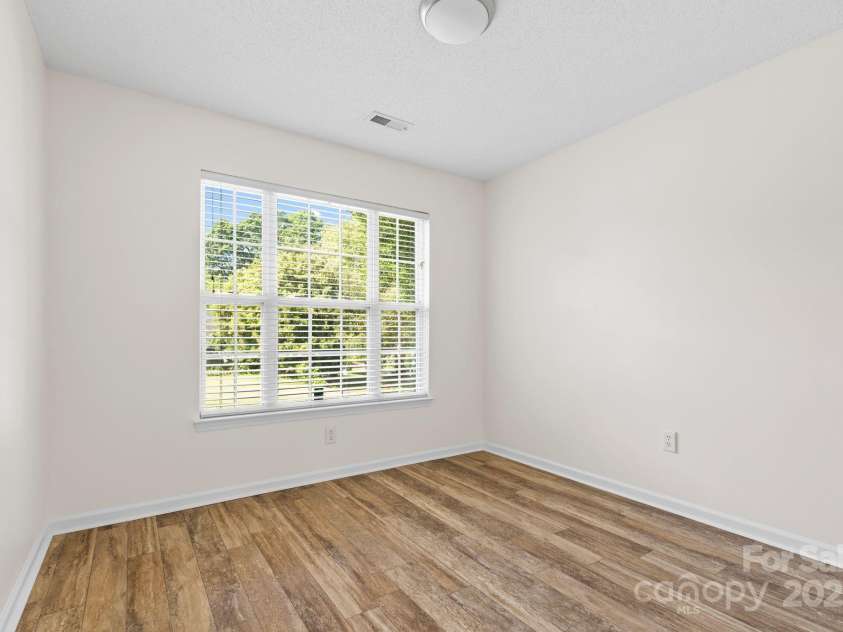 131 Canopy Court, Mooresville, NC 28115.  MLS# CAR4268984, YatesRealty ID 22713. Secondary bedroom with large front-facing window and natural light.