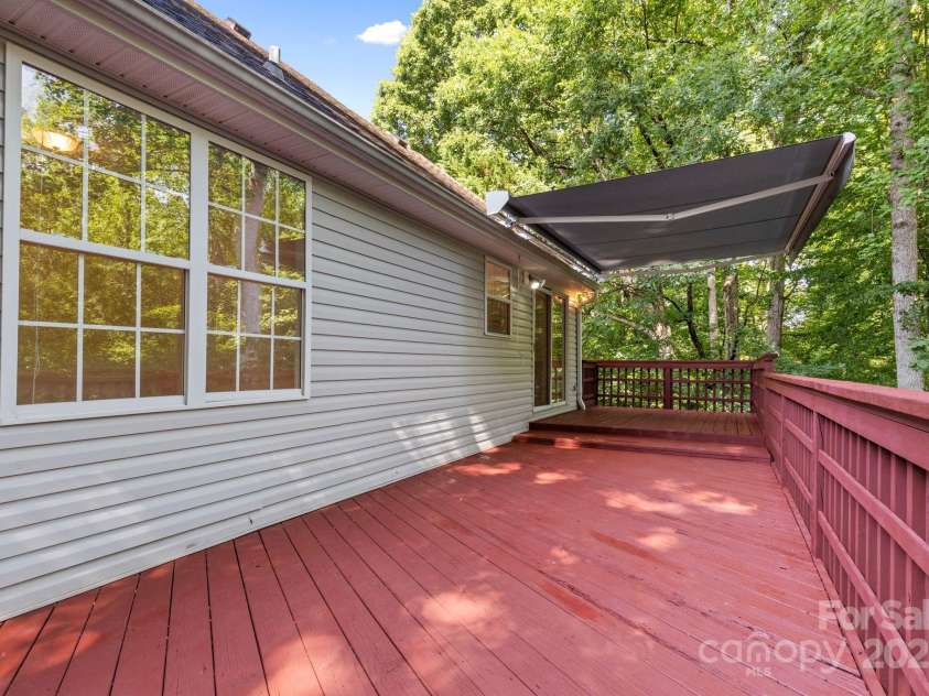 131 Canopy Court, Mooresville, NC 28115.  MLS# CAR4268984, YatesRealty ID 22713. Spacious back deck with retractable awning—ideal for relaxing or entertaining.