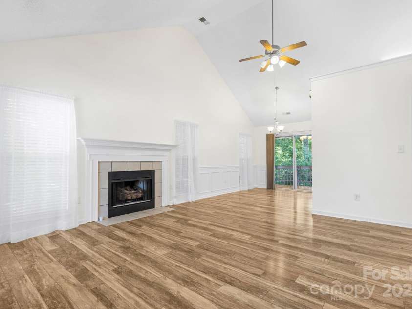 131 Canopy Court, Mooresville, NC 28115.  MLS# CAR4268984, YatesRealty ID 22713. Spacious great room with vaulted ceilings and gas fireplace—perfect for cozy nights or casual entertaining.