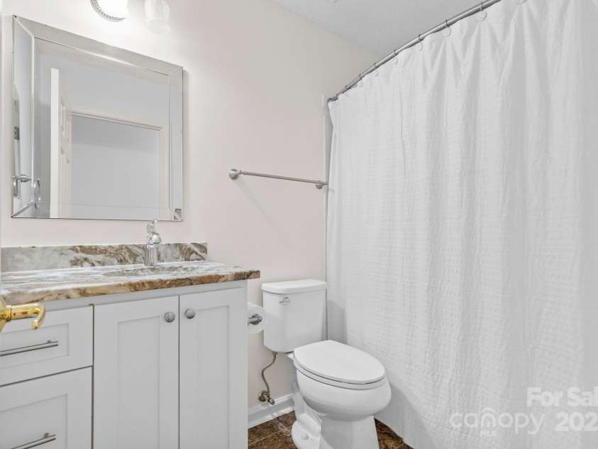 131 Canopy Court, Mooresville, NC 28115.  MLS# CAR4268984, YatesRealty ID 22713. Updated guest bath with granite-look vanity, modern mirror, and fresh fixtures.