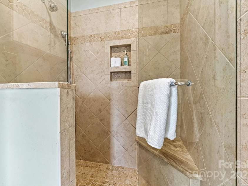 1007 Southwest Drive, Davidson, NC 28036.  MLS# CAR4271868, YatesRealty ID 22720. Large tiled primary shower with seat