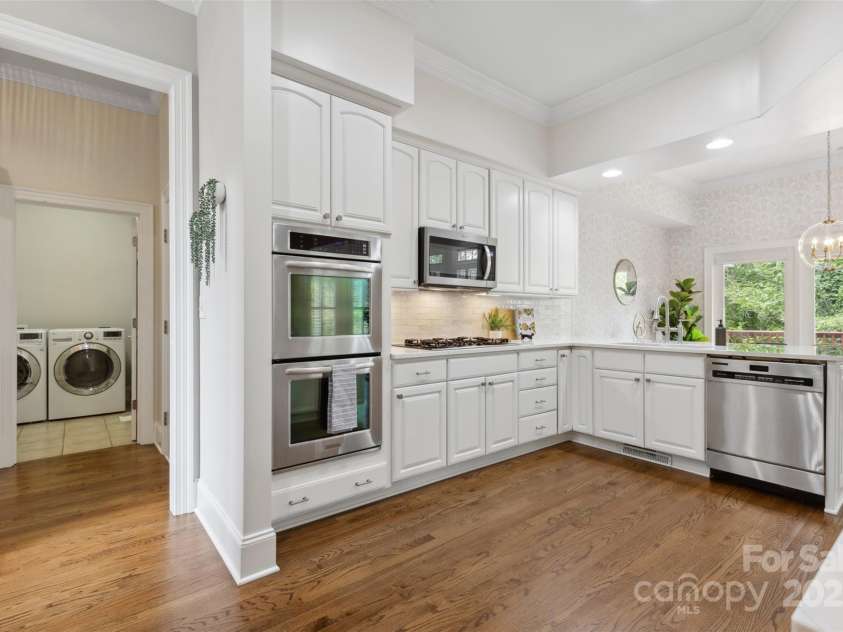 1806 Asbury Hall Court, Charlotte, NC 28209.  MLS# CAR4265884, YatesRealty ID 22727. Backing up to kitchen is 2-car garage and laundry room.