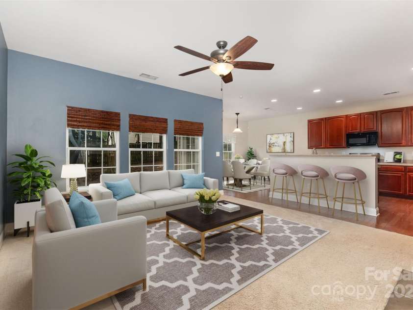 237 Lylic Woods Drive, Fort Mill, SC 29715.  MLS# CAR4268225, YatesRealty ID 22729. Virtually staged living room open to kitchen and eat-in dining.