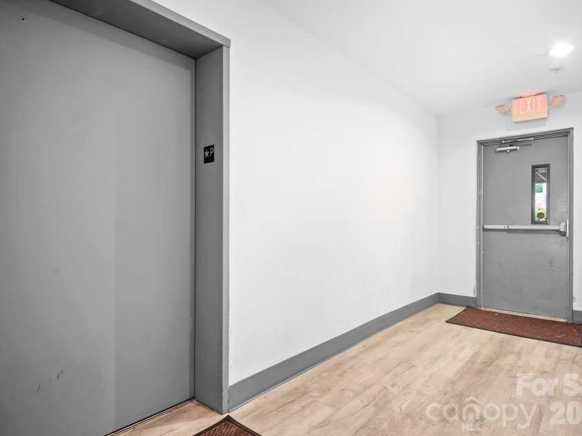 1611 Central Avenue, Charlotte, NC 28205.  MLS# CAR4378247, YatesRealty ID 22730. Downstairs Elevator from Covered Garage. Bright Hallway, secured door access.