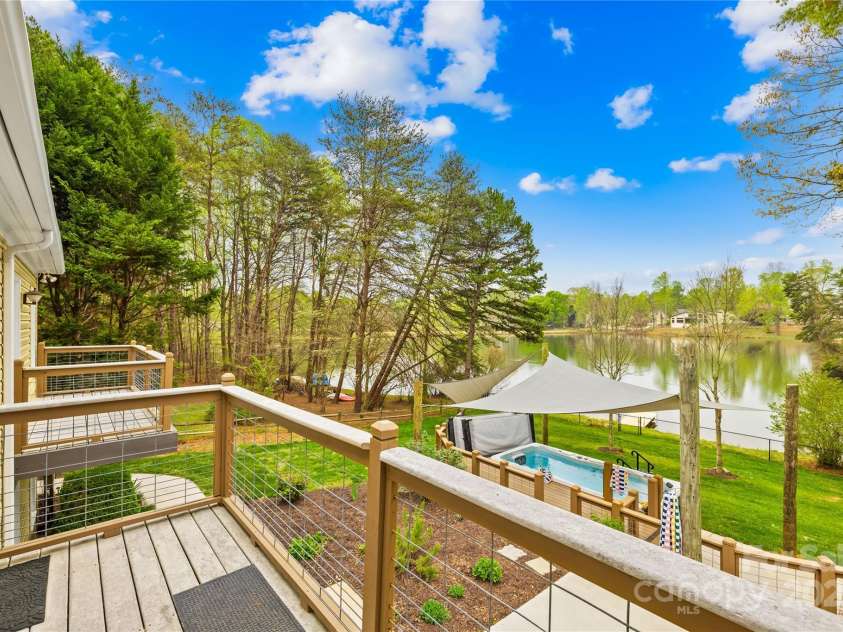 158 Regency Road, Mooresville, NC 28117.  MLS# CAR4242113, YatesRealty ID 22733. Balcony off Living Rm/Dining space and leads to the screened porch