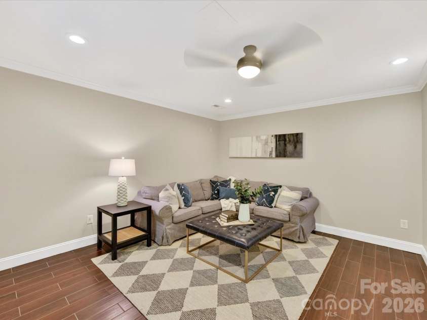 19040 Oakhurst Boulevard, Cornelius, NC 28031.  MLS# CAR4373641, YatesRealty ID 22748. Flexible lower-level room with modern flooring and recessed lighting, ideal for a guest suite, home office, or additional living space.