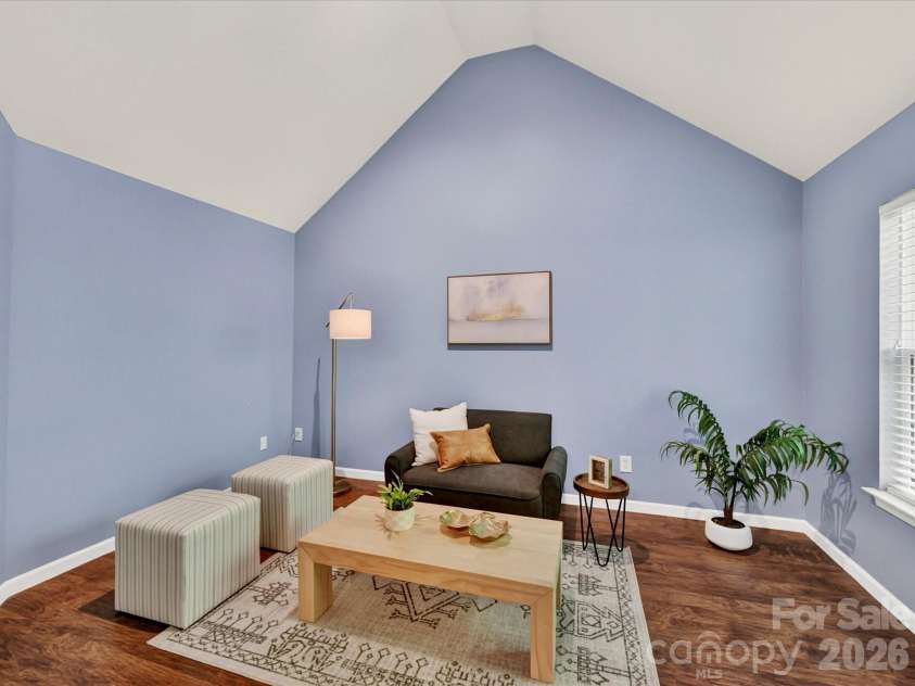 19040 Oakhurst Boulevard, Cornelius, NC 28031.  MLS# CAR4373641, YatesRealty ID 22748. Private primary suite sitting area with vaulted ceilings, offering a cozy and versatile space perfect for relaxing, reading, or a home office nook.