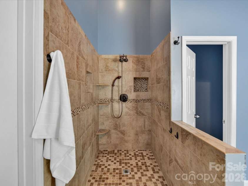 19040 Oakhurst Boulevard, Cornelius, NC 28031.  MLS# CAR4373641, YatesRealty ID 22748. Spa-like primary bath featuring a freestanding soaking tub, custom tiled walk-in shower, and dual vanity with stylish finishes throughout.