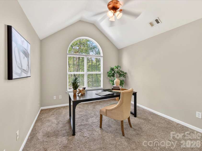 19040 Oakhurst Boulevard, Cornelius, NC 28031.  MLS# CAR4373641, YatesRealty ID 22748. Versatile fourth bedroom with vaulted ceilings and a large arched window, ideal for a home office, guest room, or flex space filled with natural light.