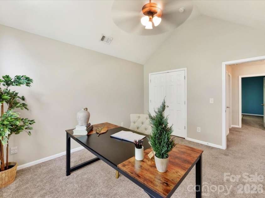 19040 Oakhurst Boulevard, Cornelius, NC 28031.  MLS# CAR4373641, YatesRealty ID 22748. Versatile fourth bedroom with vaulted ceilings and a large arched window, ideal for a home office, guest room, or flex space filled with natural light.