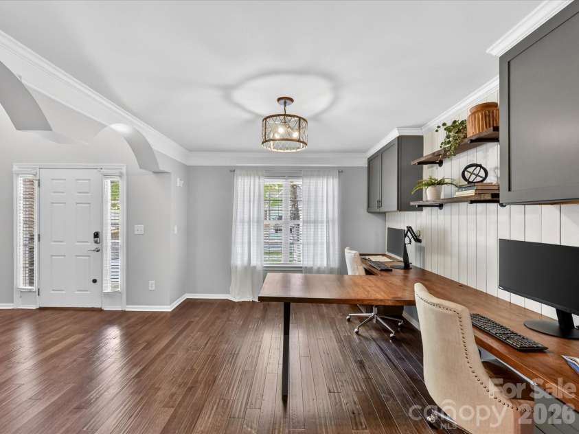 19040 Oakhurst Boulevard, Cornelius, NC 28031.  MLS# CAR4373641, YatesRealty ID 22748. Versatile living/flex space with custom built-in desks and cabinetry, perfect for a stylish home office, study area, or additional entertaining space.