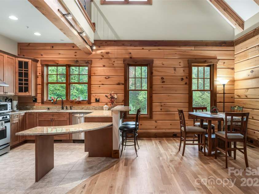 635 Whisper Mountain Drive, Leicester, NC 28748.  MLS# CAR4302796, YatesRealty ID 2275. Elegant and inviting kitchen with breakfast bar and open to formal dining 