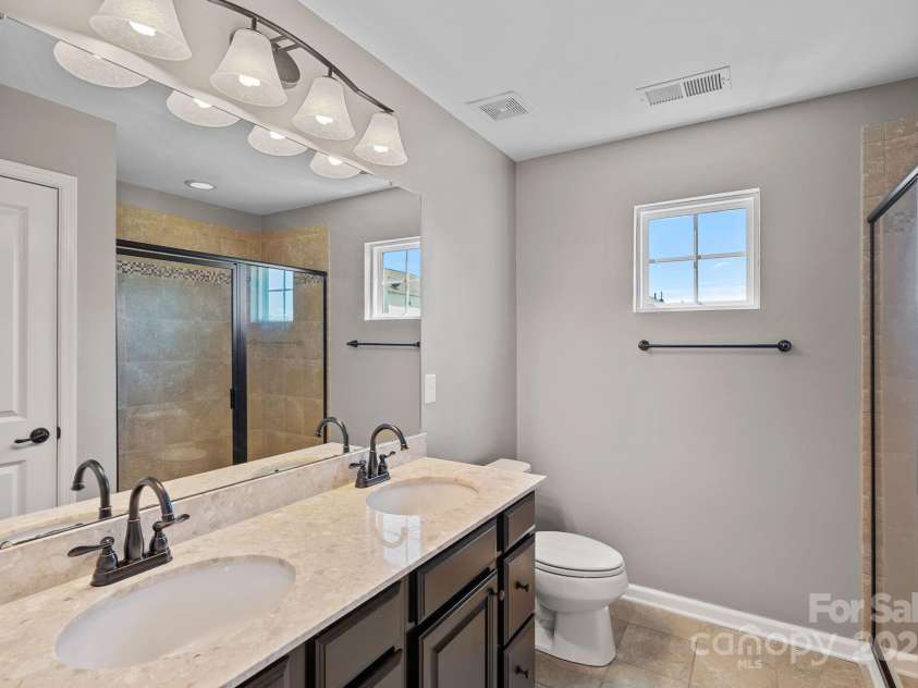 321 Almora Loop, Mooresville, NC 28115.  MLS# CAR4269481, YatesRealty ID 22755. Dual vanities and oversized shower in primary bathroom