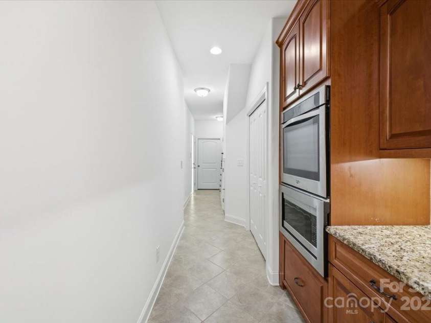 2369 Stardust Court, Denver, NC 28037.  MLS# CAR4272602, YatesRealty ID 22758. Kitchen looking down hall towards garage and laundry room