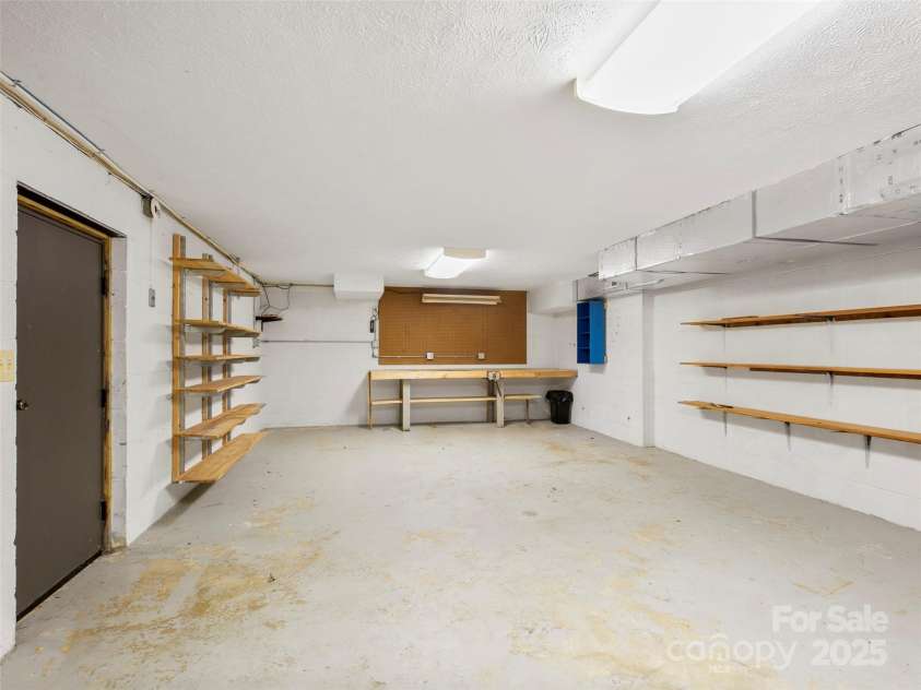 205 Wild Oak Lane, Hendersonville, NC 28791.  MLS# CAR4240419, YatesRealty ID 22765. Basement with workshop area and lots of storage space