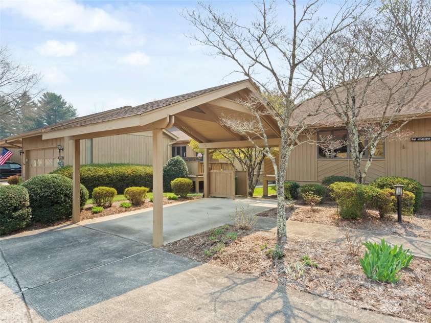 205 Wild Oak Lane, Hendersonville, NC 28791.  MLS# CAR4240419, YatesRealty ID 22765. Carport in front of home