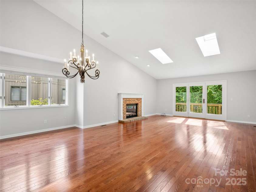 205 Wild Oak Lane, Hendersonville, NC 28791.  MLS# CAR4240419, YatesRealty ID 22765. Dining and Living Room with gas fireplace