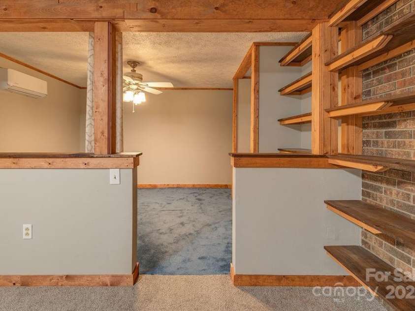 1 Spring Hill Drive, Hendersonville, NC 28792.  MLS# CAR4247945, YatesRealty ID 22767. Flex space connected to basement den