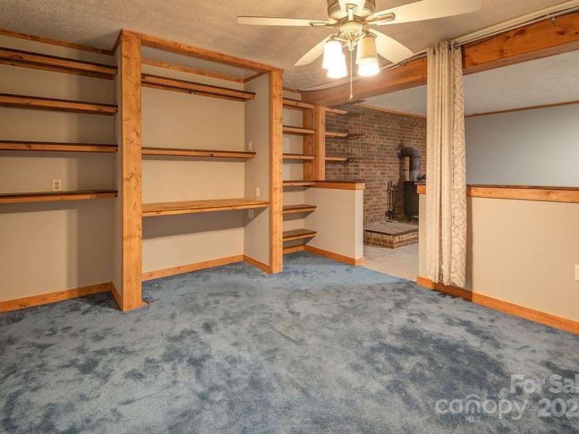 1 Spring Hill Drive, Hendersonville, NC 28792.  MLS# CAR4247945, YatesRealty ID 22767. Flex space connected to basement den