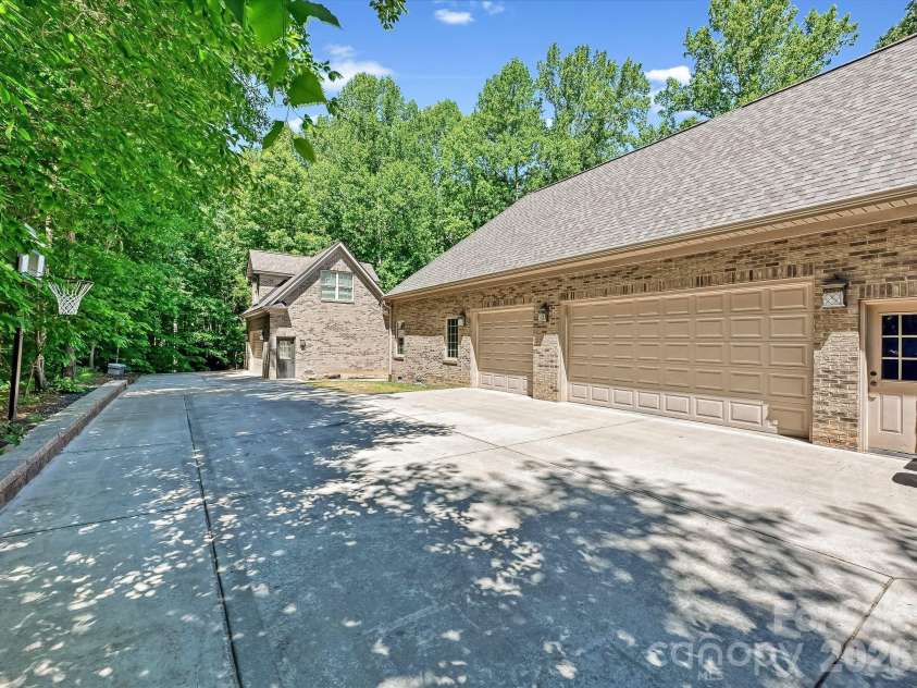 1023 Trinity Ridge Parkway, Fort Mill, SC 29715.  MLS# CAR4372318, YatesRealty ID 22784. Attached three-car garage with extended driveway for additional parking.