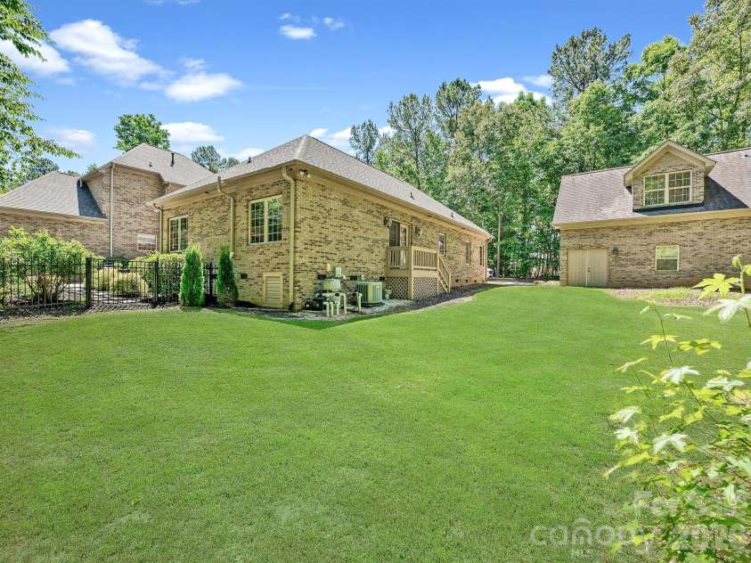 1023 Trinity Ridge Parkway, Fort Mill, SC 29715.  MLS# CAR4372318, YatesRealty ID 22784. Rear elevation showcasing main home and detached garage structure.