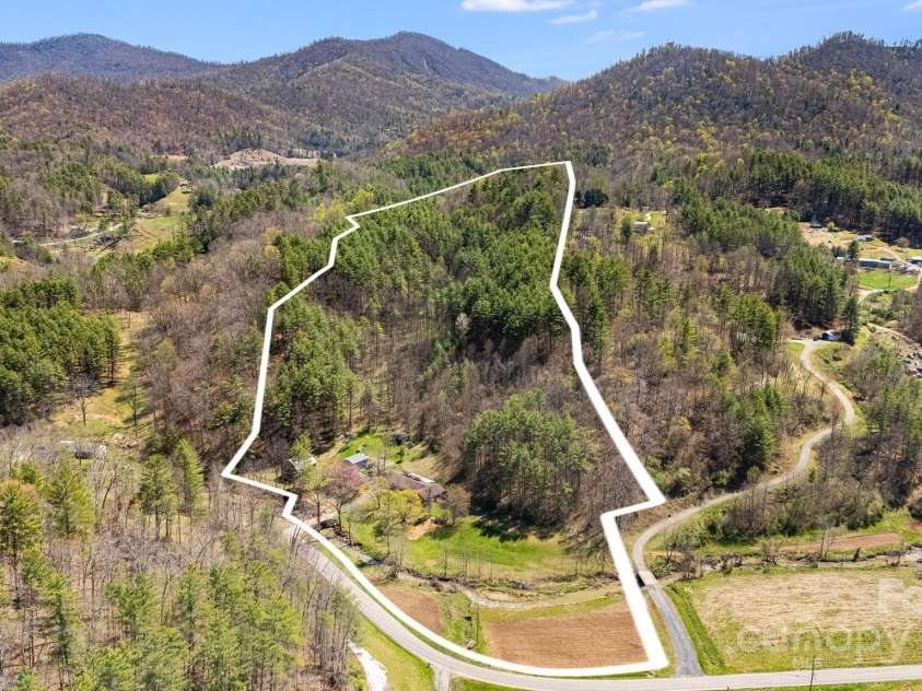 6334 Jacks Creek Road, Burnsville, NC 28714.  MLS# CAR4259403, YatesRealty ID 22798. 2 Homes on 18 acres w/ a bold creek, pasture, farmland, pond, multi purpose barn, make this the ideal farm & homestead.