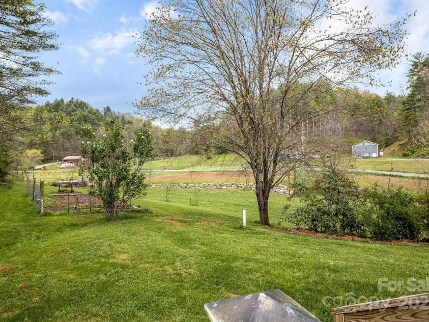 6334 Jacks Creek Road, Burnsville, NC 28714.  MLS# CAR4259403, YatesRealty ID 22798. Fenced in vegetable garden. Established herb, apple trees & berry garden
