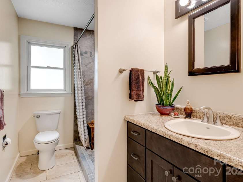 6334 Jacks Creek Road, Burnsville, NC 28714.  MLS# CAR4259403, YatesRealty ID 22798. Full bath with walk-in tile shower.