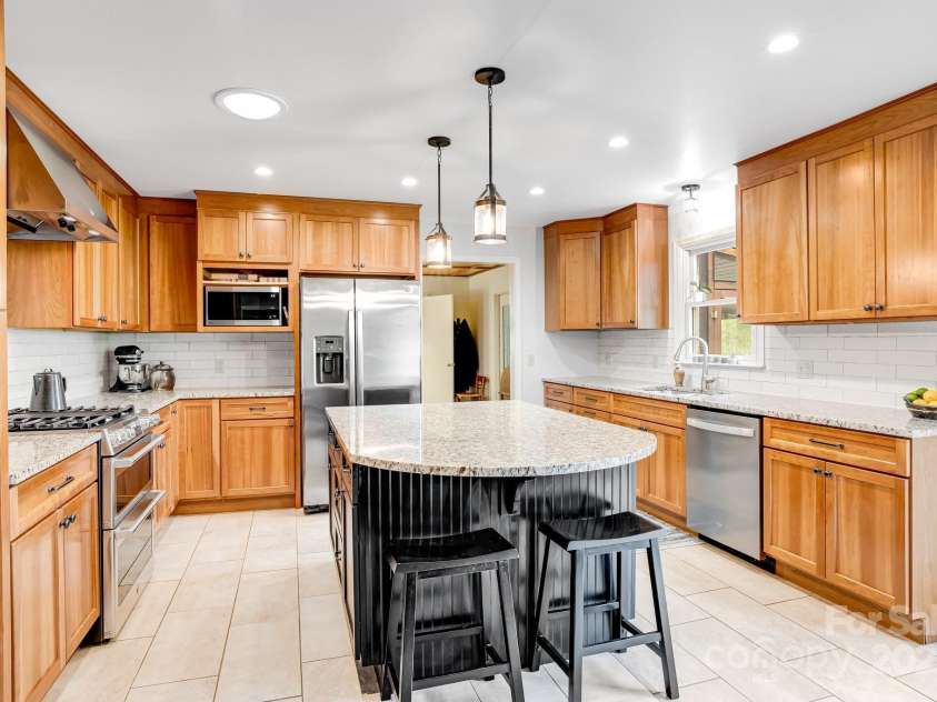 6334 Jacks Creek Road, Burnsville, NC 28714.  MLS# CAR4259403, YatesRealty ID 22798. Prep island w/extra seating & storage below.