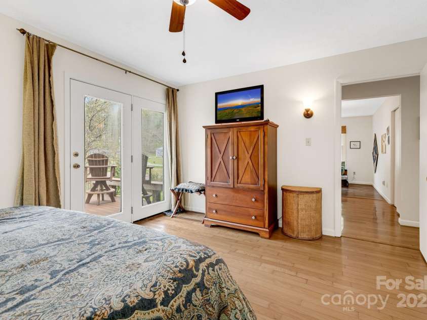 6334 Jacks Creek Road, Burnsville, NC 28714.  MLS# CAR4259403, YatesRealty ID 22798. Primary bedroom w/ensuite, sundeck w/ jacuzzi & private office space.
