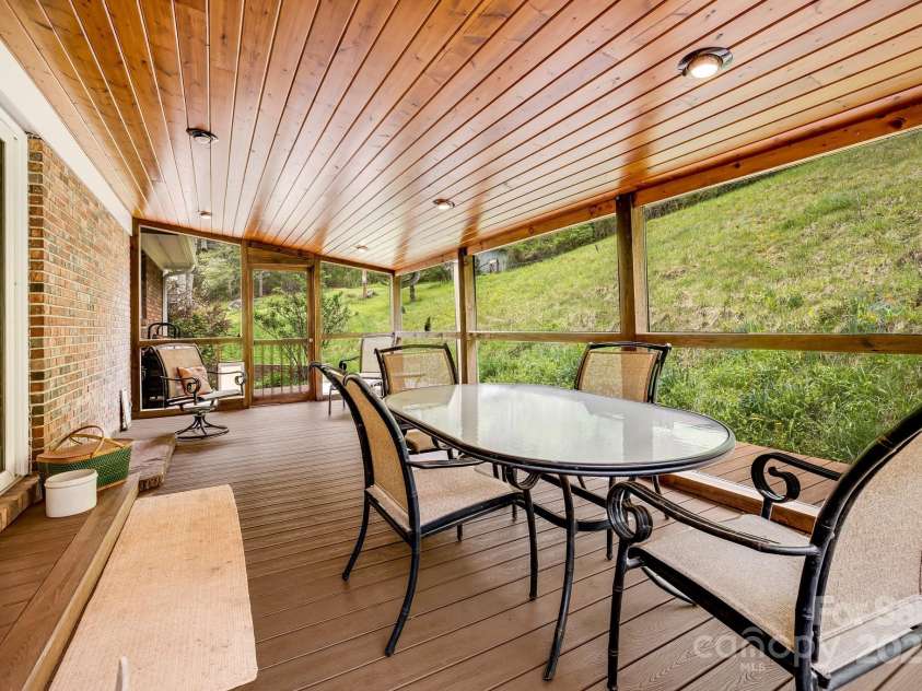 6334 Jacks Creek Road, Burnsville, NC 28714.  MLS# CAR4259403, YatesRealty ID 22798. Screened in porch off of the dining room.
