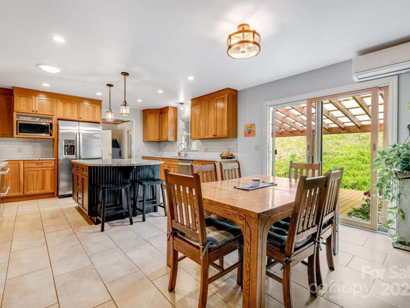 6334 Jacks Creek Road, Burnsville, NC 28714.  MLS# CAR4259403, YatesRealty ID 22798. The kitchen leads out onto the covered back deck.