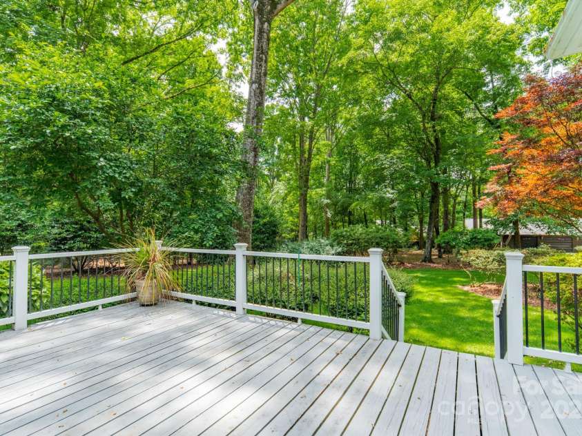 532 Courtney Lane, Matthews, NC 28105.  MLS# CAR4252271, YatesRealty ID 22805. Back deck off of the sunroom is the perfect spot to sit and enjoy your peaceful backyard.
