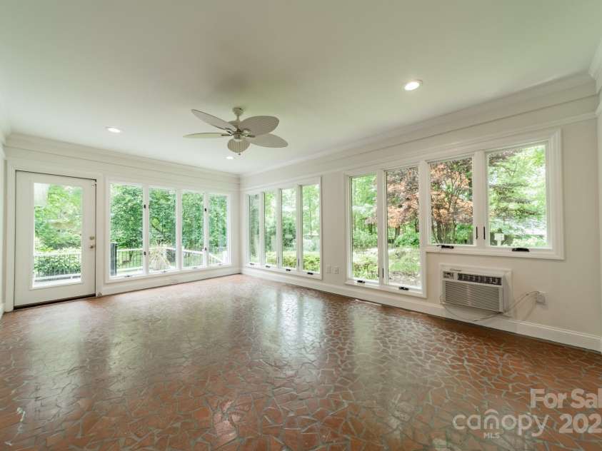532 Courtney Lane, Matthews, NC 28105.  MLS# CAR4252271, YatesRealty ID 22805. Light-filled sunroom looking out onto the deck and to the expansive backyard.