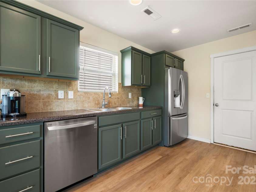 4732 Gibbons Link Road, Charlotte, NC 28269.  MLS# CAR4273619, YatesRealty ID 22817. Stainless steel appliances and modern Pewter green cabinets