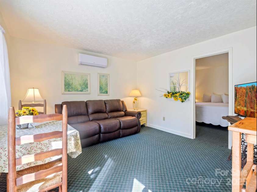 3207 Memorial Highway, Lake Lure, NC 28746.  MLS# CAR4088956, YatesRealty ID 2288. Add'l living quarter with separate exterior entrance facing the back yard and river has potential to be used as a STVR. Needs to be refinished. Photos were taken prior to the hurricane.