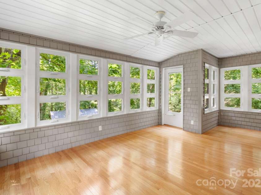 115 Aurora Drive, Asheville, NC 28805.  MLS# CAR4273830, YatesRealty ID 22887. Heated Sunroom leading to back  yard